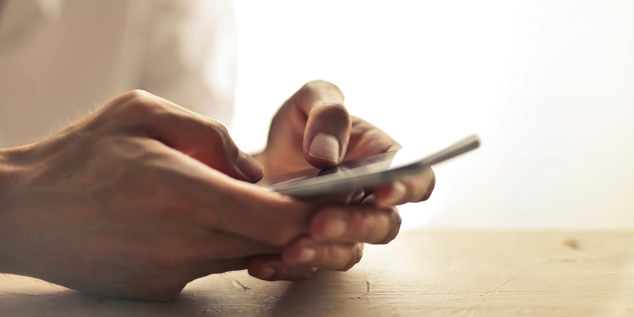 Two hands holding a smartphone.