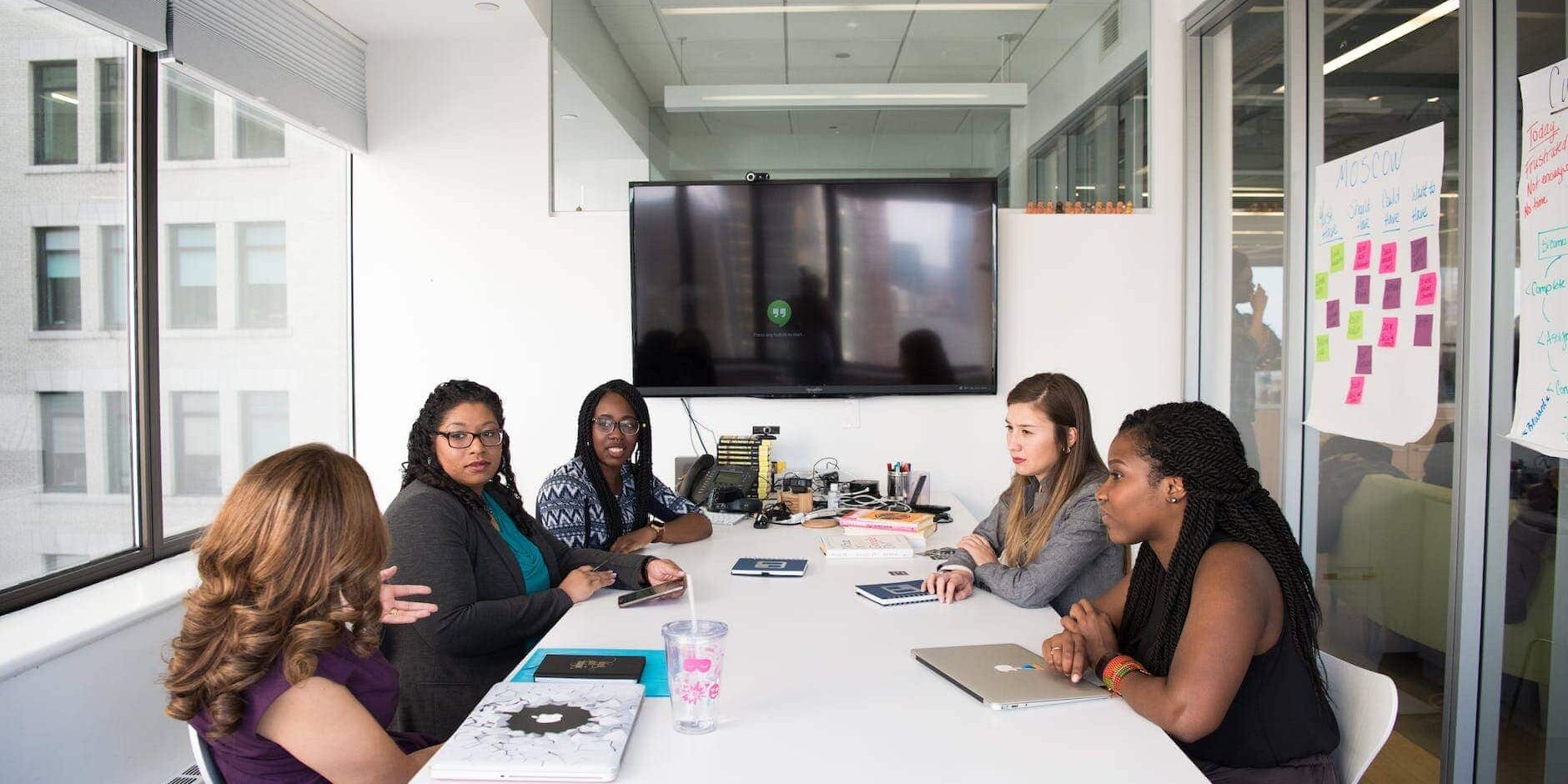 group of women gathered inside conference room