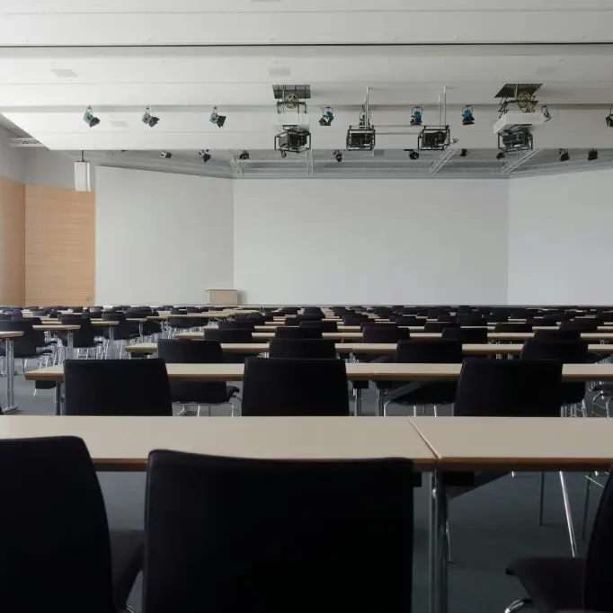 Empty conference room with large whiteboard and projectors